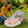 couffin bébé gris travelbaby dans le jardin
